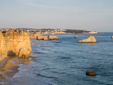 a view of a beach with rocks in the water