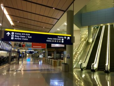 Airport terminal with escalators and signs