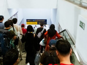 People using an escalator in a modern building