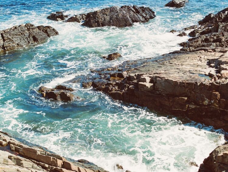 a view of a body of water near some rocks