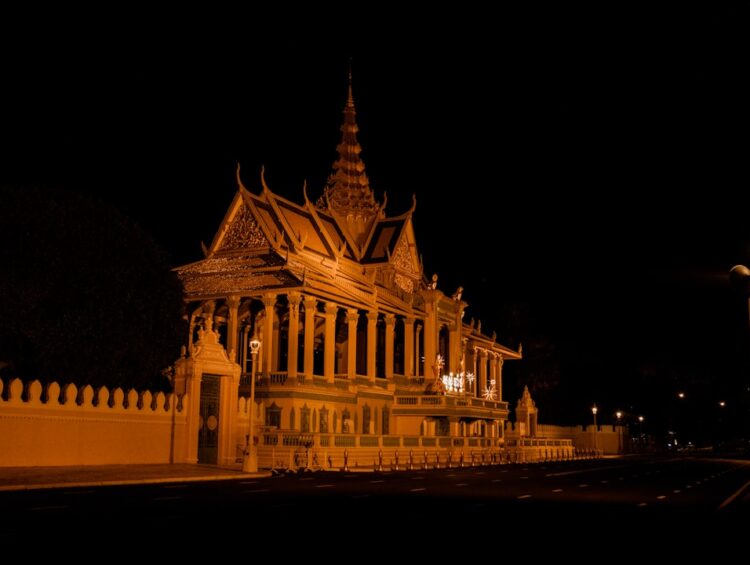 a large building with a clock tower at night