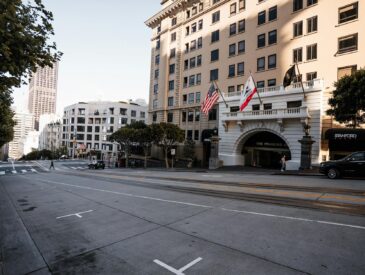 Streetscape of San Francisco featuring the Stanford Court Hotel and city architecture.