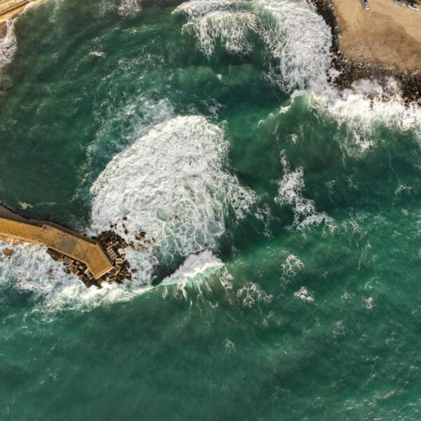 Aerial shot of Pizzo's coastline capturing vibrant waves and scenic sea views.