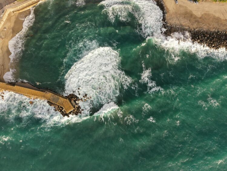 Aerial shot of Pizzo's coastline capturing vibrant waves and scenic sea views.
