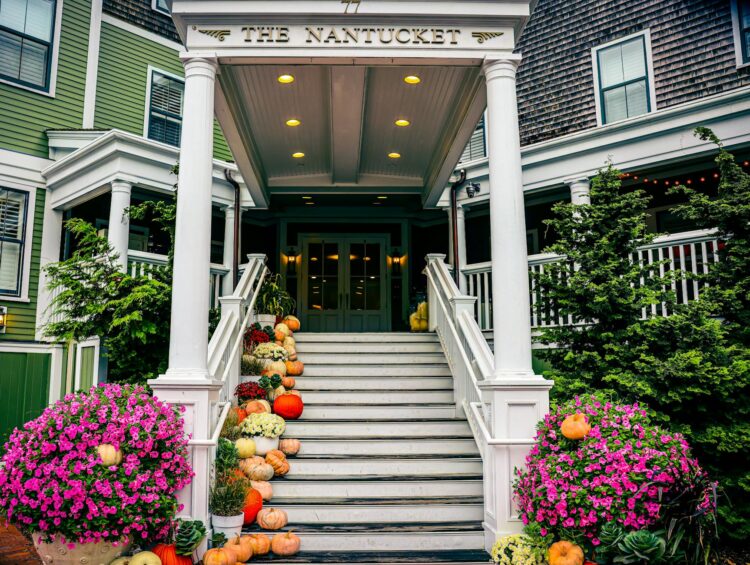 Inviting staircase decorated with pumpkins in Nantucket during fall season.