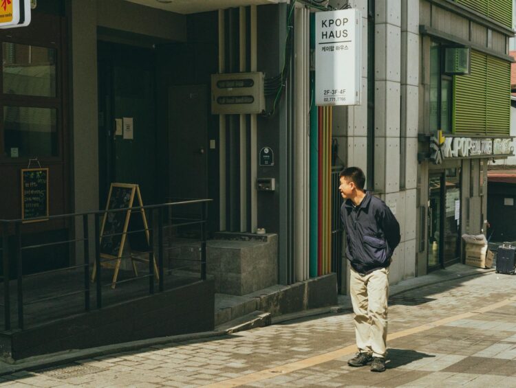 A man walks in front of a K-pop themed building in downtown Seoul, South Korea.