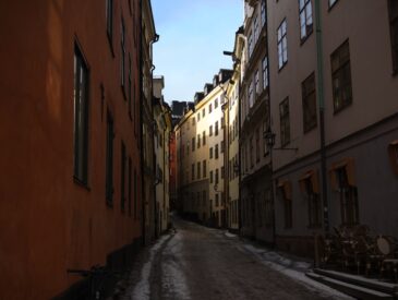 Narrow street lined with buildings on a sunny day