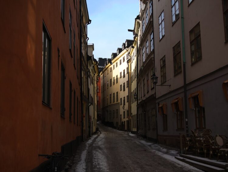 Narrow street lined with buildings on a sunny day