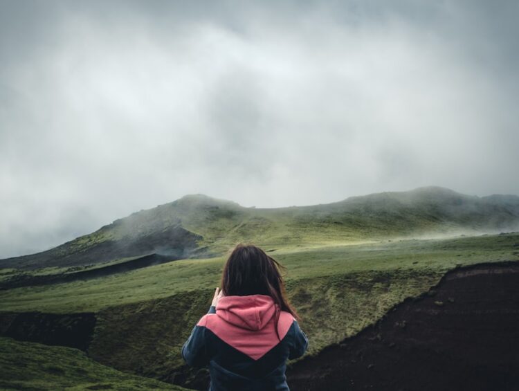 a person sitting on a hill